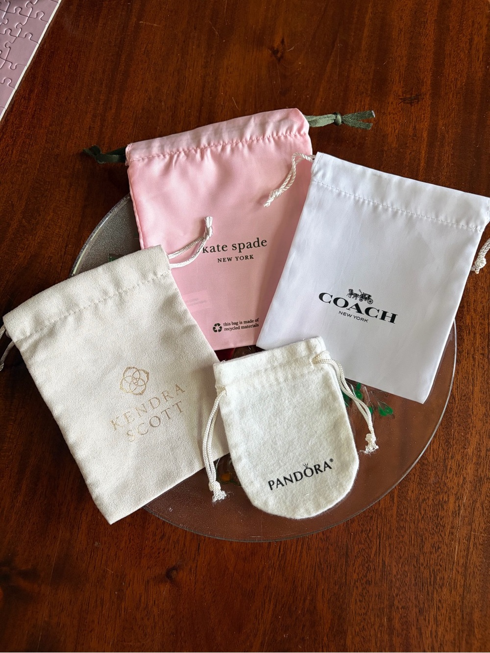 New Set of 4 jewelry dustbags. Coach, kate spade, Pandora and Kendra Scott